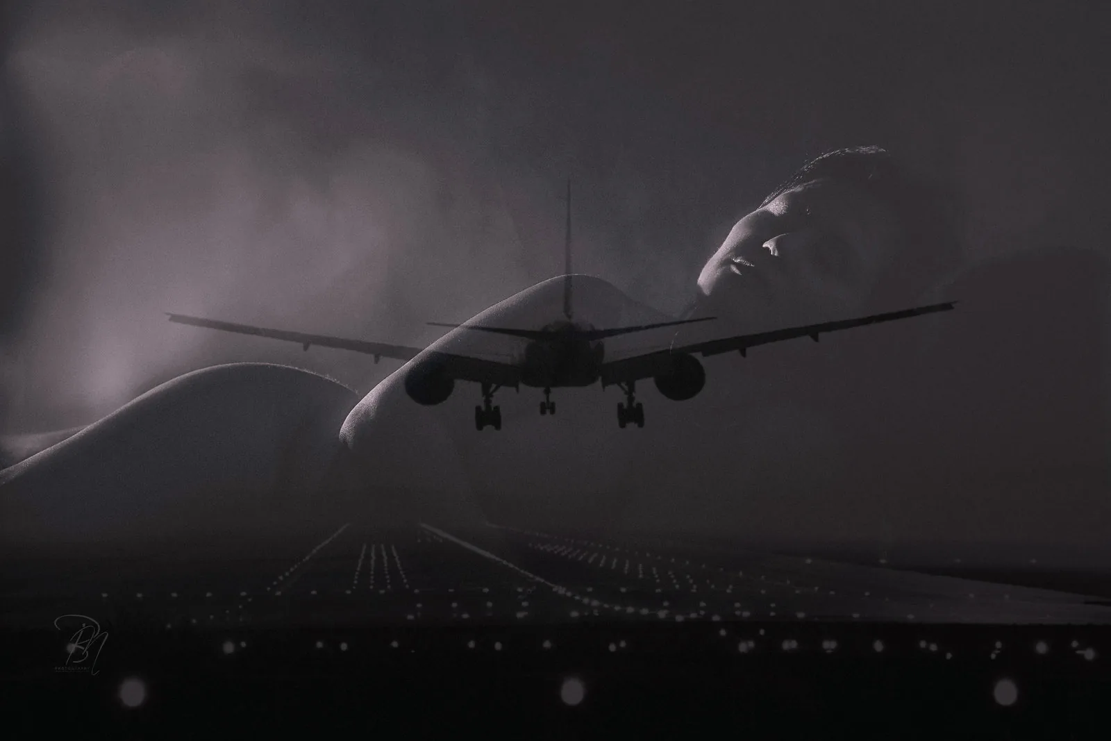 Runway — Photo: Norbert Banhalmi An aircraft comes in to land across a reclining silhouette and a lit runway.